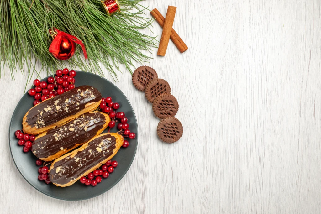 A beautifully arranged Christmas bark recipe featuring chocolate, candy canes, nuts, and festive sprinkles on a rustic wooden table