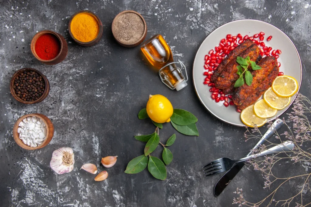 Crispy fish prepared with a homemade fish fry seasoning recipe, surrounded by fresh ingredients like spices, garlic, and lemon.