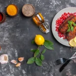 Crispy fish prepared with a homemade fish fry seasoning recipe, surrounded by fresh ingredients like spices, garlic, and lemon.