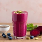 Blueberry beet smoothie in a glass with chia seeds and pistachios
