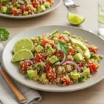 A colorful bowl of quinoa salad with avocado, tomato, and red onion served fresh—perfect for a healthy Peru diet recipe.