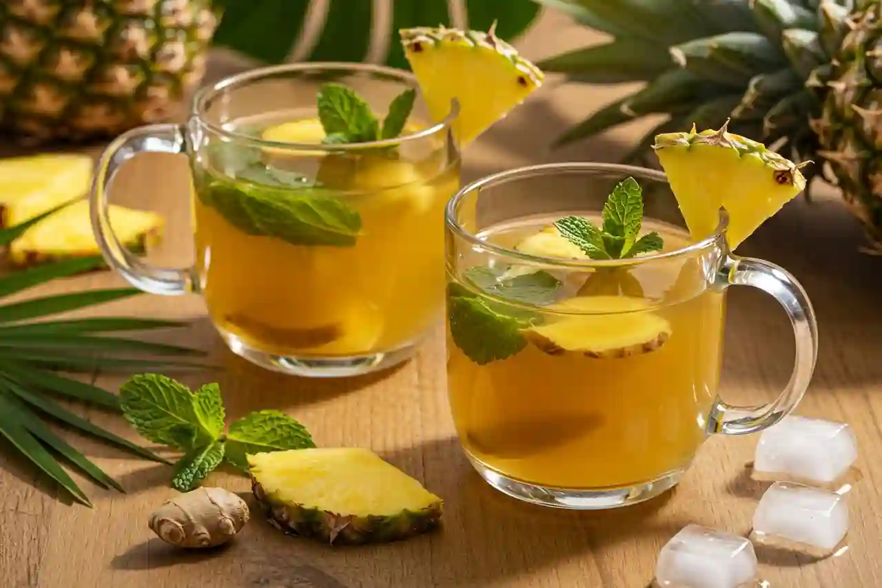 Glass cups of Costa Rican tea with pineapple and mint