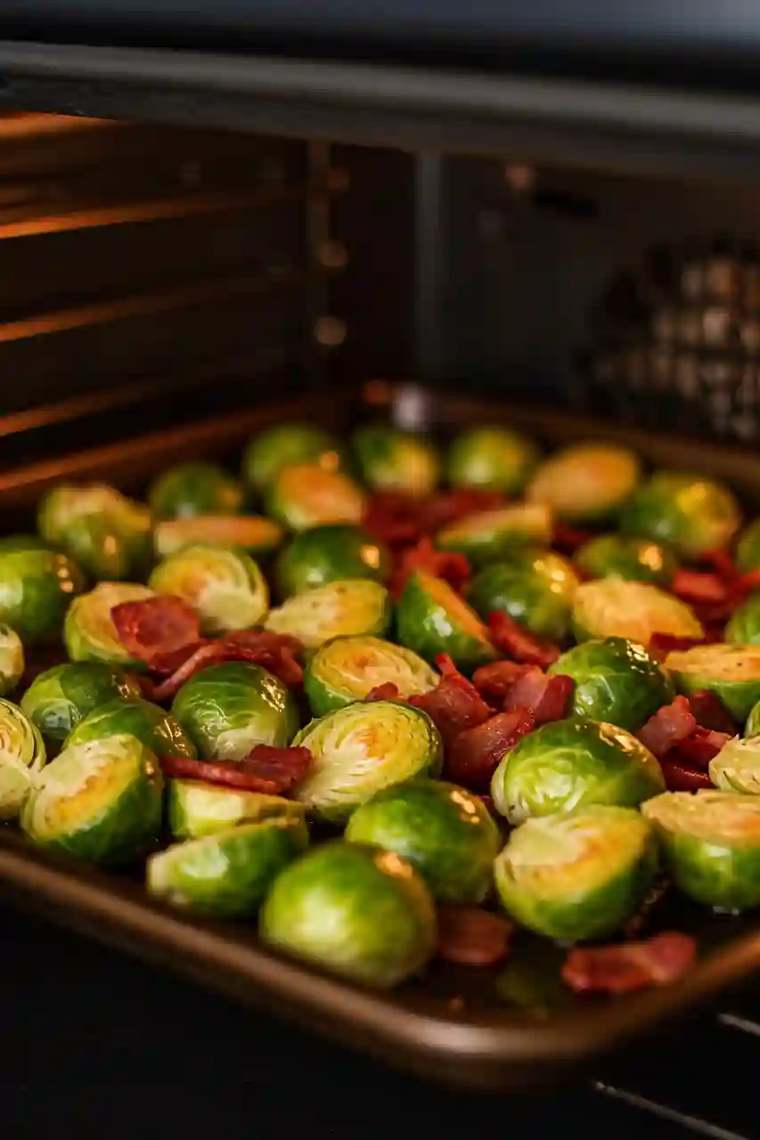 Roasting Brussels sprouts with bacon Brussels sprouts with bacon roasting on a sheet pan in the oven