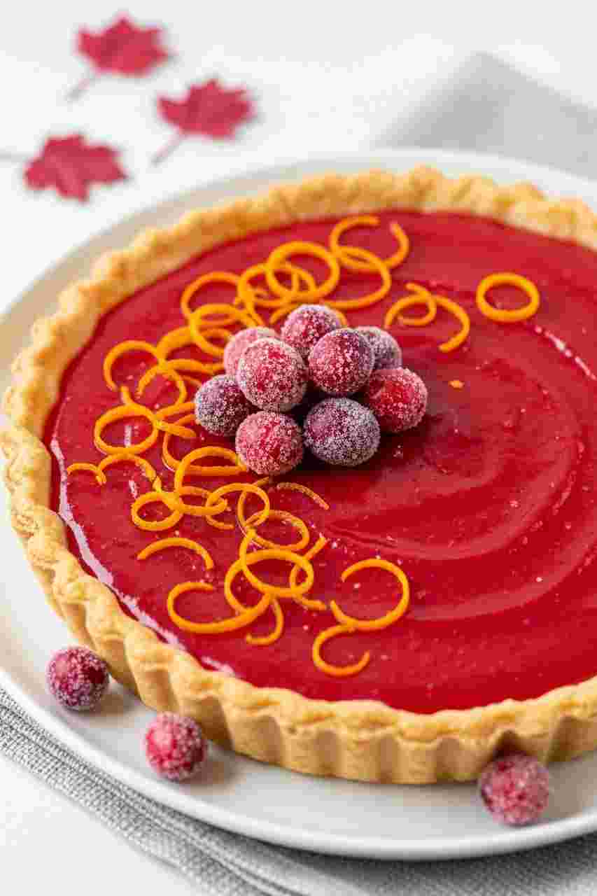 Bright cranberry orange curd tart with buttery crust and sugared cranberries, a vibrant Thanksgiving desserts recipe.